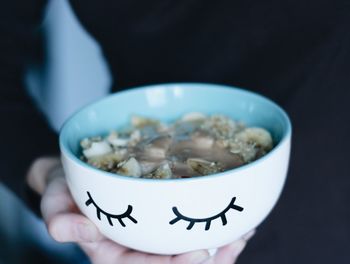 Close-up of hand holding bowl