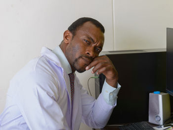 Portrait of young man sitting at home