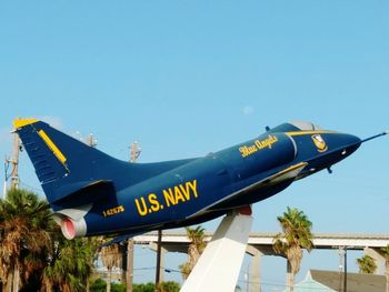 Low angle view of airplane against clear blue sky