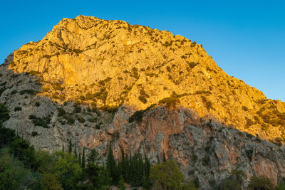 Low angle view of rock formation against sky