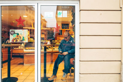 Man sitting in front of store