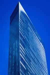 Low angle view of modern building against clear blue sky