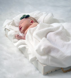 Portrait of young woman sleeping on bed at home