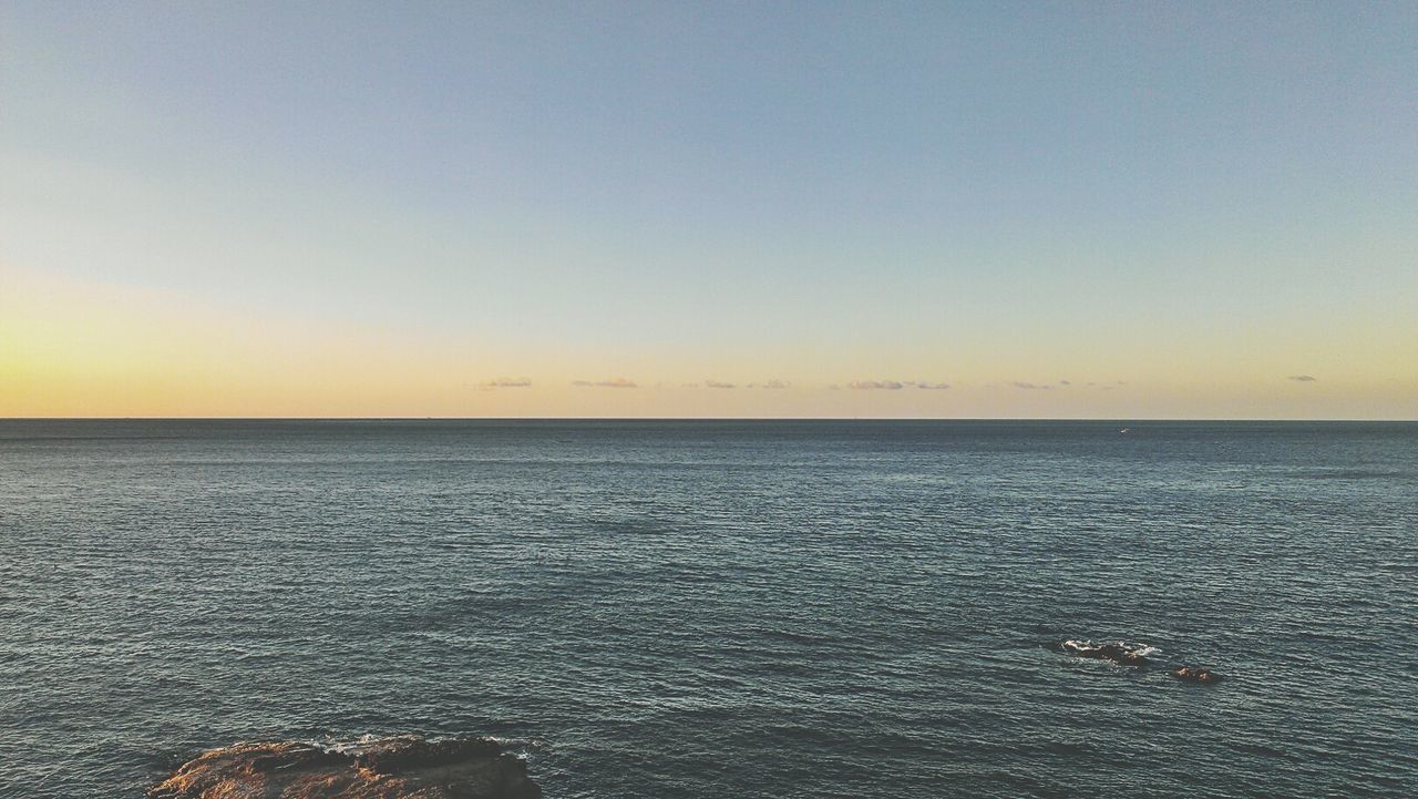 sea, water, horizon over water, tranquil scene, scenics, tranquility, beauty in nature, copy space, sunset, waterfront, nature, clear sky, sky, idyllic, seascape, rippled, outdoors, remote, no people, calm