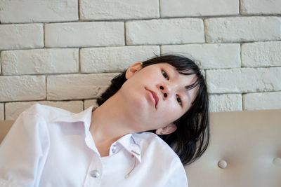 Portrait of young woman sitting on sofa