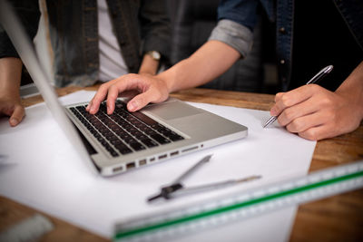 Midsection of man using mobile phone