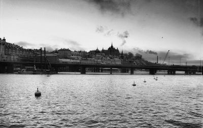 Bridge over river with buildings in background