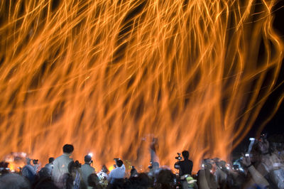 Group of people against sky at night