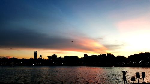 Scenic view of river against romantic sky at sunset