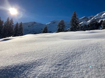 Surface level of snowcapped mountains against clear sky