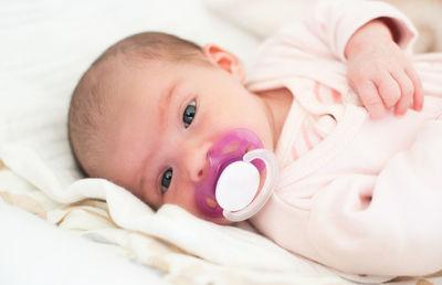 Close-up of cute baby boy sleeping on bed at home