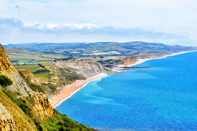 High angle view of sea and mountains against sky