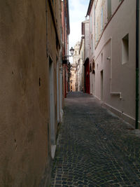 Alley amidst buildings against sky