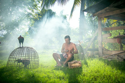 People sitting on land against trees