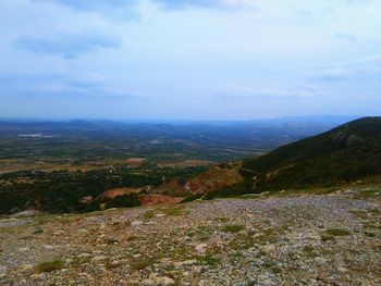 Scenic view of landscape against cloudy sky