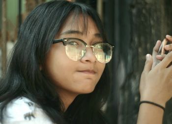 Close-up of young woman wearing sunglasses