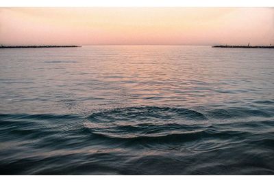 Scenic view of sea against clear sky during sunset