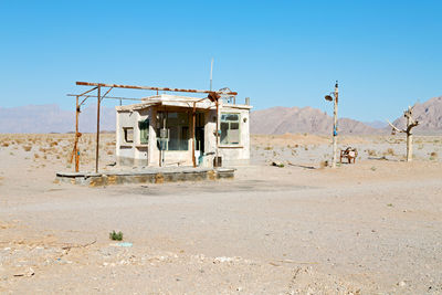 Built structure on desert against clear blue sky