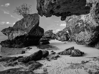 Rocks on beach against sky