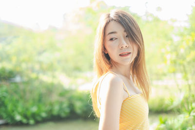 Portrait of a beautiful young woman standing outdoors