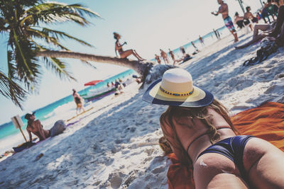 People on beach against sky