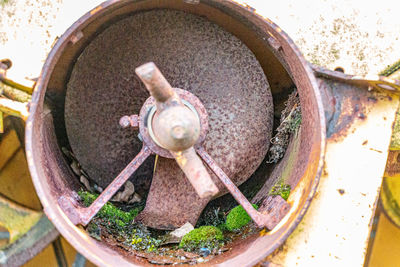 High angle view of rusty wheel in container