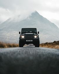 Vintage car on road against sky