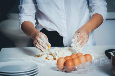 Midsection of man preparing food