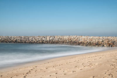 Scenic view of beach against clear sky