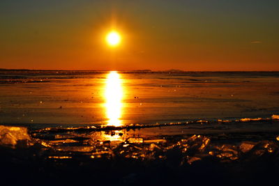 Scenic view of beach against sky during sunset