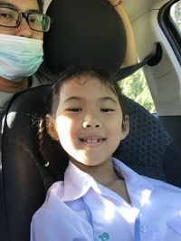 Portrait of a smiling girl in car