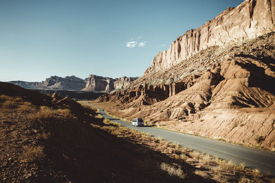 Panoramic view of road amidst mountains against clear sky