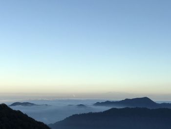 Scenic view of silhouette mountains against clear sky