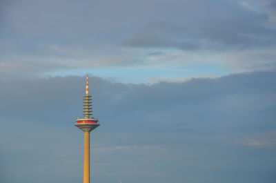 Low angle view of communications tower against sky