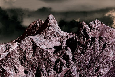 Close-up of rock formation against sky