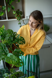 Portrait of young woman standing in kitchen