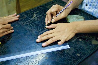Cropped hands of woman making craft