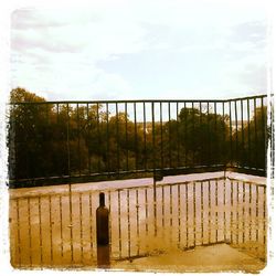 Fence against cloudy sky