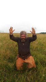 Full length of man sitting on field