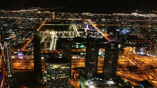 High angle view of illuminated buildings in city at night