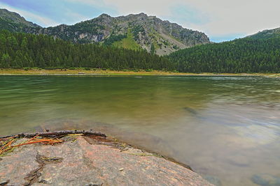 Scenic view of lake and mountains against sky