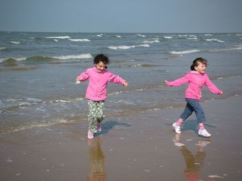 Full length of girl enjoying at beach