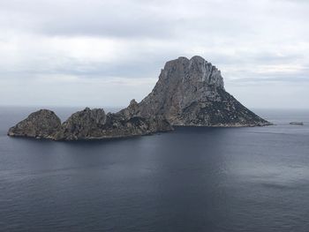 Scenic view of rock formation in sea against sky