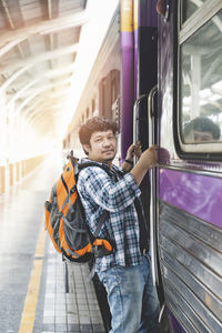 Rear view of woman standing in train