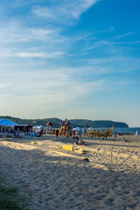 People on beach against sky