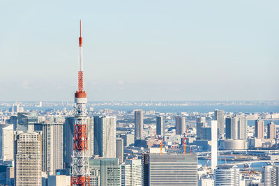 Tower amidst buildings in city against sky