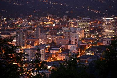 High angle view of illuminated city buildings at night