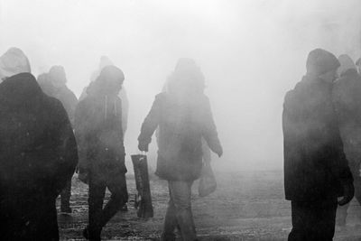 People on road with smoke