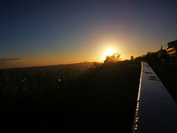 Scenic view of silhouette landscape against clear sky during sunset