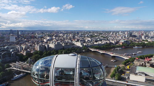 High angle view of millennium wheel against sky in city